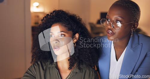 Image of Training, night and business women planning a marketing project together on a tablet in a dark office. African employees working overtime to design a website for a corporate startup company with tech