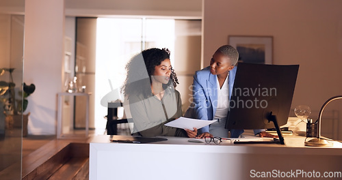 Image of Business women, planning and night discussion of documents, paperwork and data report for kpi research, strategy analytics and economy analysis. Female employees computer collaboration in dark office