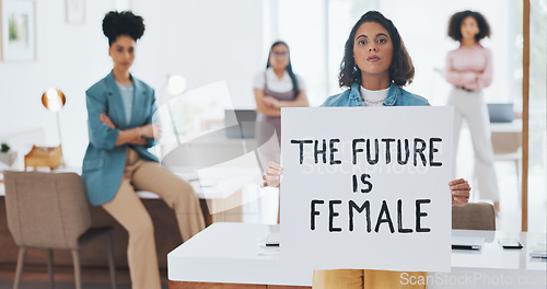 Image of Equality, empowerment and female leader holding a sign in the office with her business woman group at work. Future, human rights and diversity with a feminism team working for revolution or change