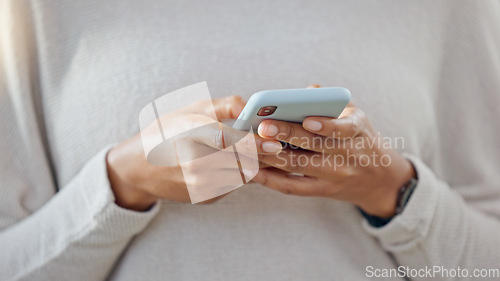 Image of Person holding a phone while texting on social media. One trendy woman writing a quick and convenient text message on an instant chat app. Closeup of a girl browsing content online or on the internet