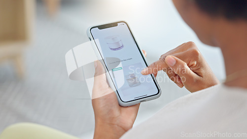 Image of Shopping online and scrolling through makeup products to find a sale or discount. Hands of a woman browsing cosmetics on her phone from above. Enjoying the convenience and ease of purchasing apps