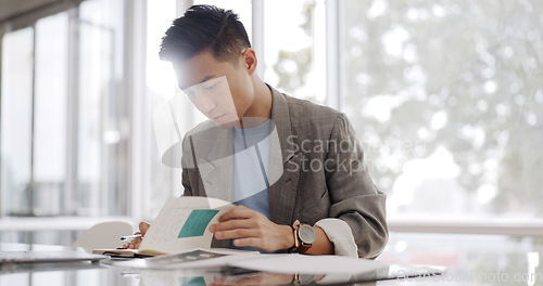 Image of Businessman, writing report and documents with business plan proposal in conference room and company strategy in Japan. Employee focus, Asian man working with notes and pen, development and growth