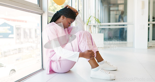 Image of Stress, doctor and black woman on floor, headache and hospital with depression, burnout and anxiety. Healthcare, African American female or medical professional on ground, mental health or frustrated