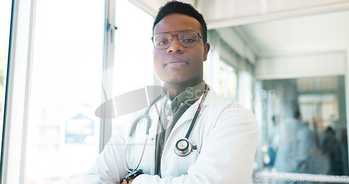 Image of Black man, face or doctor arms crossed in hospital with surgery ideas, life insurance vision or medical wellness goals. Portrait, healthcare worker or thinking medicine employee in trust innovation