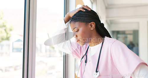 Image of Nurse, stress thinking and hospital window for relax breathing, stress relief and healthcare worker frustrated or overworked. Black woman, employee burnout and anxiety headache working in clinic