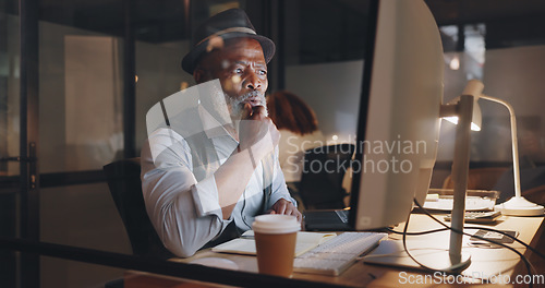 Image of Businessman, focus and computer, typing and working overtime, journalist writing article for newspaper. Office, night and professional at desk, computer screen and technology with deadline.