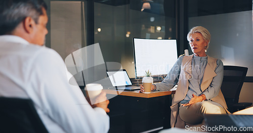 Image of Mockup, man and woman conversation at night, office or planning schedule for marketing, collaboration or corporate deal. Digital, staff and talking, discussion and in workplace for brainstorming idea