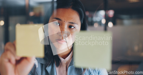 Image of Sticky note, writing or woman planning a strategy for financial, sales or business growth in an office at night. Focus, data analysis or employee thinking of goals, mission or vision working on ideas