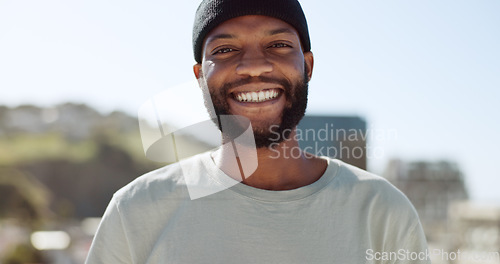 Image of Happy black man standing outdoor in the city with a smile on his face. Portrait, freedom and carefree with a young male gesturing or signing in a town