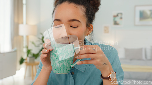 Image of Black woman, relax and coffee by home office in morning start for freelancing business at home. African American female freelancer relaxing and enjoying a warm drink by work desk in the bedroom