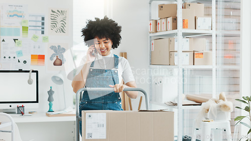 Image of Small business, woman phone call and box logistics on trolley for delivery, customer orders and product stock in startup. Black female entrepreneur, mobile talking and shipping cargo package service