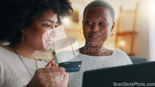 Image of Payment, credit card and friends online shopping on a laptop for discount or sale on a digital fintech website at home. Ecommerce, happy and excited African women on the sofa banking on the internet