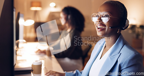 Image of Call center, support and business woman at night, working on computer, overtime or evening shift. CRM, help and black woman talking to customer on headset. Consulting agent on customer service call