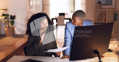 Image of Documents, collaboration and talking with a business woman team working in their office at night. Teamwork, conversation and training with a female employee explaining a report to a colleague