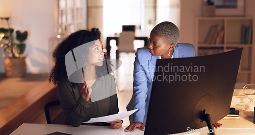 Image of Documents, collaboration and talking with a business woman team working in their office at night. Teamwork, conversation and training with a female employee explaining a report to a colleague