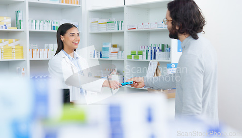Image of Patient buying medicine from pharmacist at the pharmacy store. Customer receives prescription medication at the chemist store from medical doctor. Healthcare professional accepts credit card payment