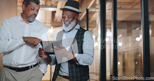 Image of Partnership, tablet and businessmen walking in the office analyzing, talking and planning a project. Technology, professional and senior male employees working on a mobile device in the workplace.