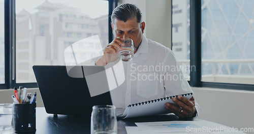 Image of Businessman, office and drink water with documents, laptop and focus for market research, analysis or target. Advertising expert, paper or strategy with data analytics, kpi or goals for marketing job