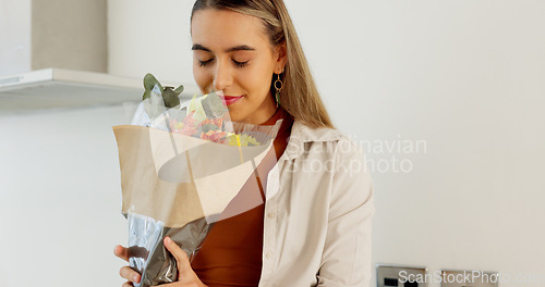 Image of Love, flowers surprise and couple in home with romantic wow surprise plant boutique gift on anniversary event. Floral bouquet, happy woman and sweet man with present for wife for celebration together