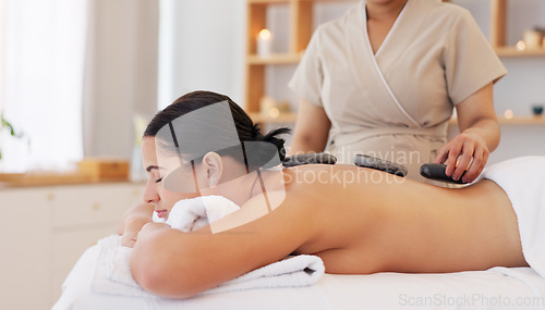 Image of Spa wellness, massage and woman relax healthy skincare wellness treatment. Young calm sleeping girl, zen therapy masseuse hands and serenity stress relief on back or body luxury hot stone detox