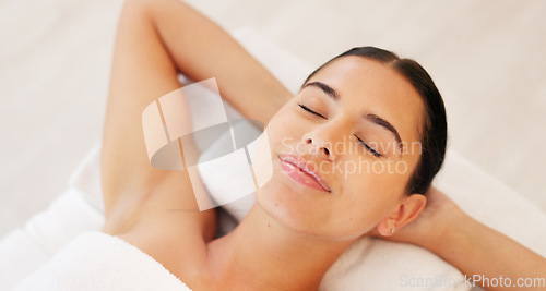 Image of Spa, wellness and woman, calm and happy, peaceful after massage, massage therapy for body health and zen. Young person satisfied, lying down and carefree with peace and serene, stress relief.