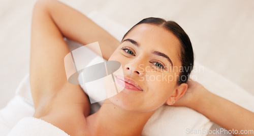 Image of Face, portrait and woman at spa for skincare, luxury massage and wellness on a bed at a hotel. Happy, smile and beauty of a young girl at a salon to relax for peace and calm during cosmetic therapy
