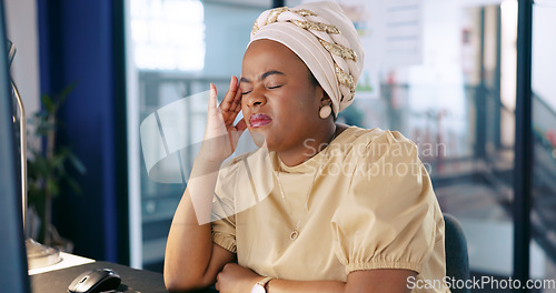 Image of Stress, headache and black woman at desk in office with head pain, overworked and frustrated with project. Burnout, mental health and stressed, tired and female worker with fatigue working at night