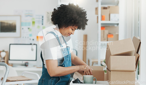 Image of Startup, delivery and shipping in boxes for online shopping business. Businesswoman packing products from online business in a box to ship to clients and buyers. Black woman working in the office