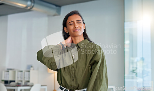 Image of Businesswoman suffering from neck pain and discomfort caused by stress burnout and anxiety in a corporate office. Employee struggling with muscle spasm and stiff joints while looking unhappy at work