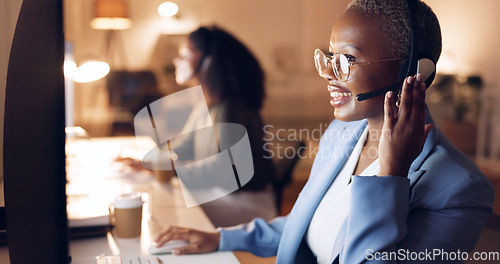 Image of Call center, customer service and night shift black woman telemarketing consultant wearing headset at computer. Sales female in contact us and crm support talking during call working late with smile