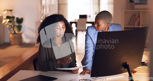 Image of Documents, collaboration and talking with a business woman team working in their office at night. Teamwork, conversation and training with a female employee explaining a report to a colleague