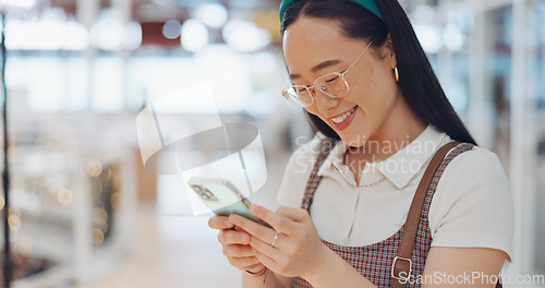 Image of Digital marketing woman, smile and phone in workplace, social network or chat at communication startup. Asian corporate executive, smartphone or happy for app, web or social media marketing in Tokyo