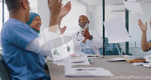 Image of Doctors, applause and high five with success and paper confetti, celebrate win in health and cheers for team building. Happy, medical innovation win and target goal with motivation and diversity.