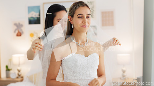 Image of Bride, wedding and woman helping with veil in dressing room smile for special day. Happy women love and bridesmaid support or helping bride with fabric head piece for beauty, marriage and happiness