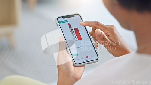 Image of Shopping online and scrolling through makeup products to find a sale or discount. Hands of a woman browsing cosmetics on her phone from above. Enjoying the convenience and ease of purchasing apps