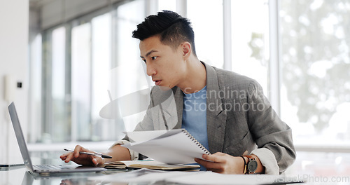 Image of Businessman, writing report and documents with business plan proposal in conference room and company strategy in Japan. Employee focus, Asian man working with notes and pen, development and growth