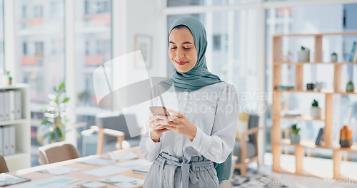 Image of Phone, thinking and feedback with a business muslim woman typing a text message in her office at work. Contact, mobile and idea with an islamic female employee reading an email while working alone