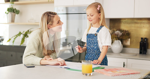 Image of Education, mother and girl writing in kitchen for school task, assignment or homework. Help, learning and mom with child teaching, explaining or helping kid in home in the morning with books on table