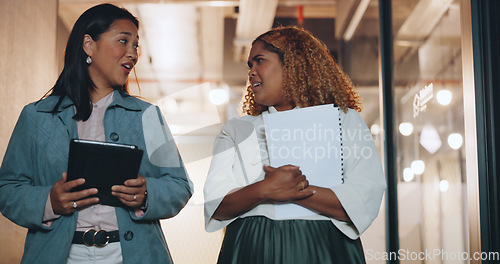 Image of Business, women talking and walking in office, conversation and brainstorming. Females, coworkers or employees with tablet, documents and discussion for marketing campaign, sales growth and workplace