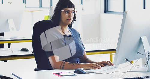 Image of Creative, serious and computer with woman in office for designer, idea and email. Technology, internet and research planning with employee typing in digital agency startup for data, vision and focus