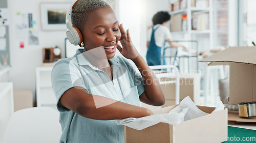 Image of Black woman, music headphones and dance in office, ecommerce shipping logistics company or creative e commerce startup. Smile, happy and excited retail worker with dropshipping product delivery boxes