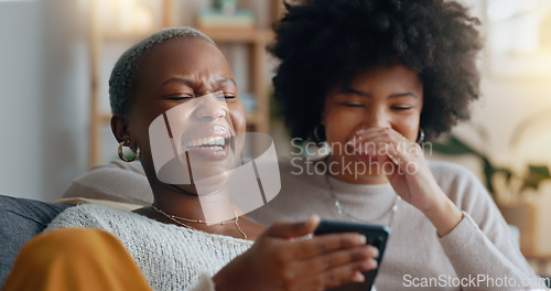 Image of Women, laugh and phone search on dating app profile, internet movie streaming and social media in house living room. Happy smile, comic friends bond or lgbtq black couple on web in home interior sofa