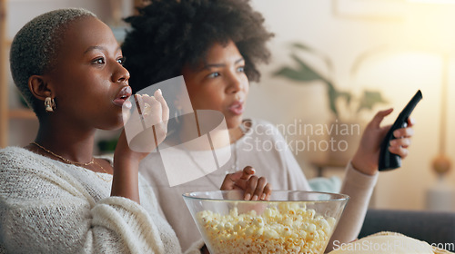 Image of Women, movie or eating popcorn and watching tv show or subscription series in house living room. Smile, happy or friends talking during media film for streaming a drama foe entertainment together