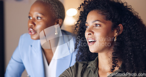 Image of Training, computer and business women speaking about management of website for company in a dark office. African workers talking, planning and working on a corporate strategy during overtime