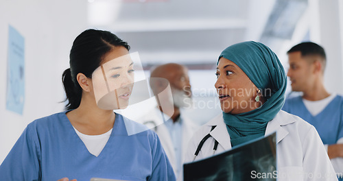 Image of Doctors, x ray and women walking in hospital, clinic and healthcare planning, consulting and teamwork. Diversity, medical workers and xray anatomy analysis for heart risk, asthma lungs and body chart