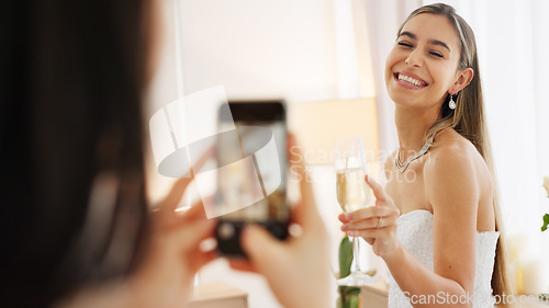 Image of Smartphone photography of bride with champagne glass for wedding celebration to post on social media app. Smile portrait photos or picture taken of woman on digital cellphone and celebrate with wine
