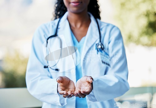 Image of Healthcare, open hands and woman doctor working in a hospital for volunteer, support or charity. Help, stethoscope and African female medical worker with a giving hand gesture in a medicare clinic.