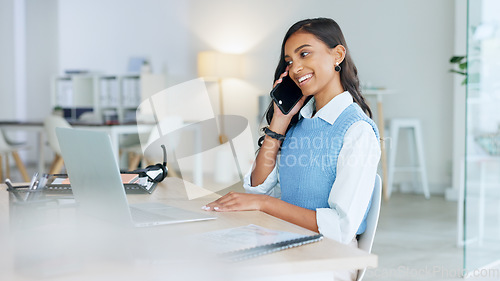 Image of Young businesswoman talking on her phone to a client in an office. Trendy marketing professional on scheduled time, using the online app for networking. Entrepreneur staying connected in a workplace