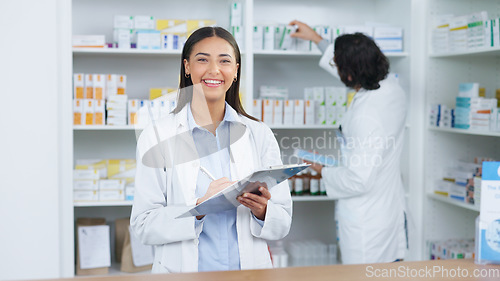Image of Portrait of a cheerful and friendly pharmacist using a digital tablet to check inventory or online orders in a chemist. Young latino woman using pharma app to do research on medication in a pharmacy