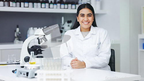 Image of Portrait of a female scientist using a microscope in a research lab. Young biologist or biotechnology researcher working and analyzing microscopic samples with the latest laboratory tech equipment